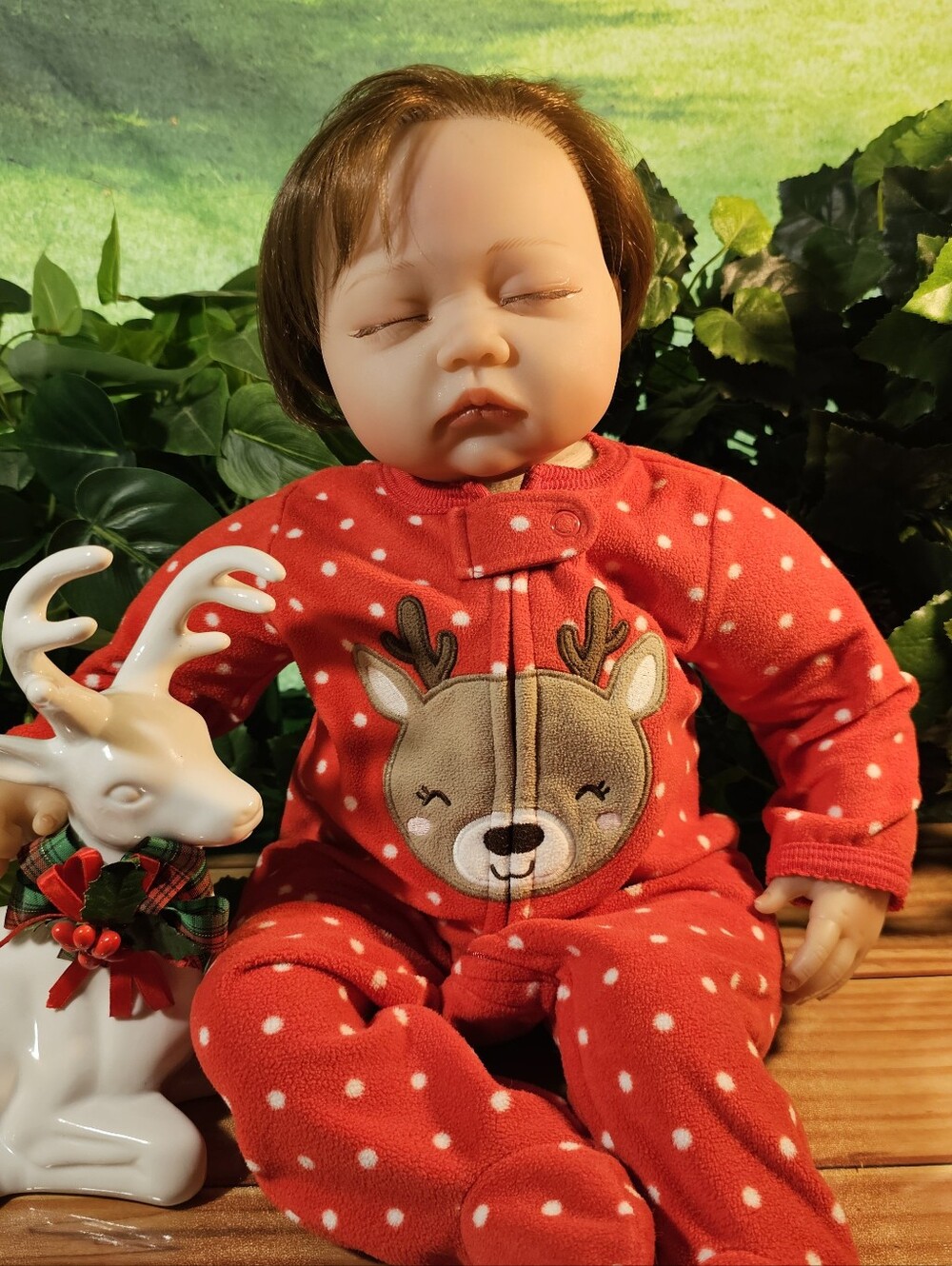 Baby Doll with brown hair, and adorable eyelashes.She is sleeping peacefully